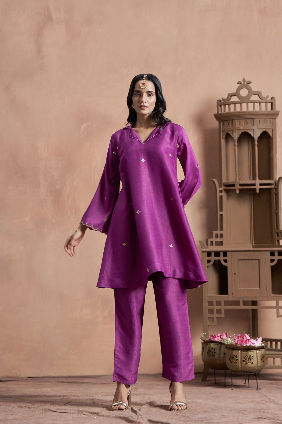 A woman wearing a purple loose-fitted outfit in musline shimmer fabric